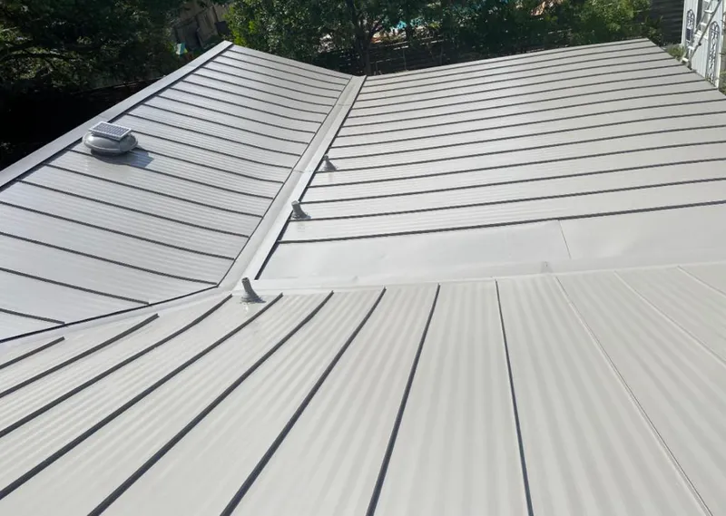 Solar attic fan installed on a metal roof for Roof Ventilation in Atlantic